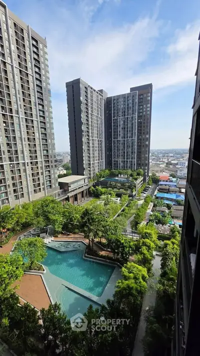 Luxurious high-rise apartment complex with stunning pool and lush greenery