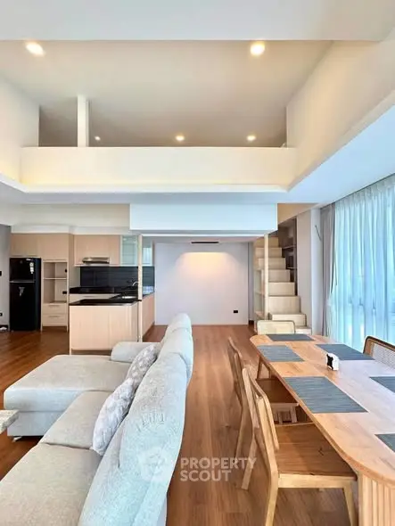 Spacious modern living room with open kitchen and stylish dining area