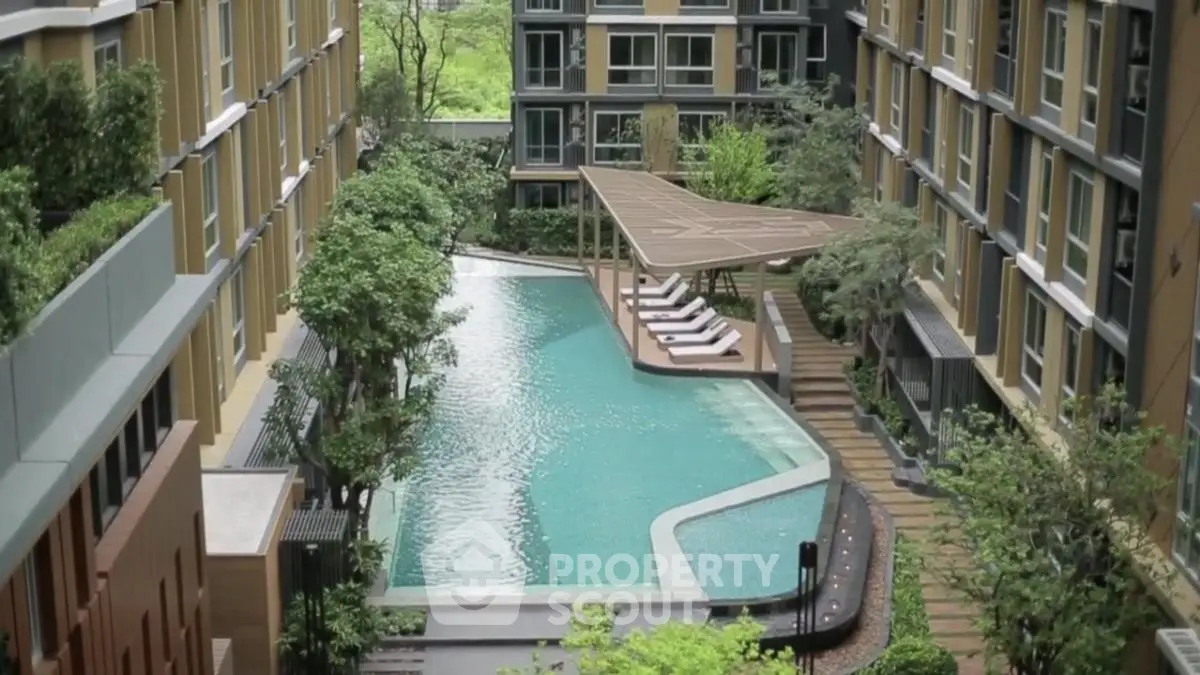 Luxurious apartment complex with stunning pool and lush greenery
