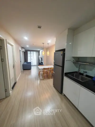 Modern open-plan kitchen and dining area with sleek design and ample natural light.