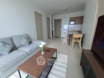 Modern living room with cozy sofa and open kitchen layout