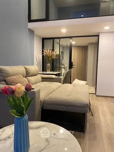 Modern living room with stylish decor and cozy seating in a contemporary apartment.