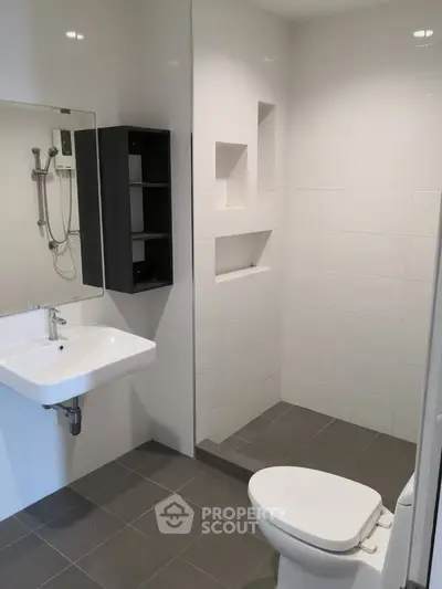 Modern bathroom with sleek white tiles and minimalist fixtures
