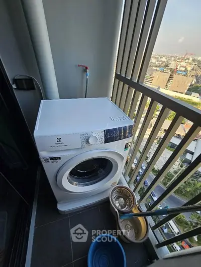 High-rise balcony with washing machine and city view, perfect for urban living convenience.