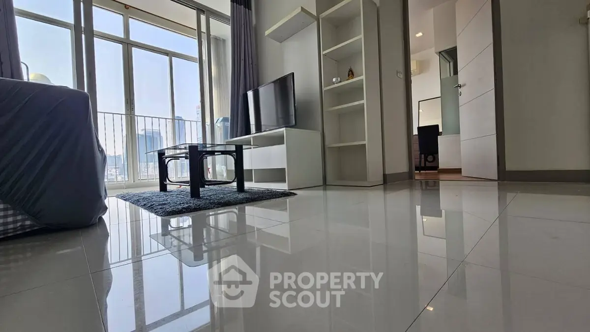 Spacious modern living room with large windows and sleek furnishings