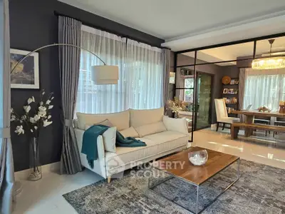 Elegant living room with modern decor and large windows in a stylish home.