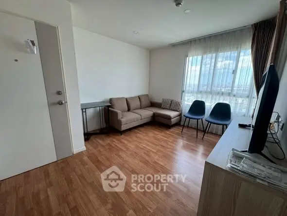 Modern living room with wooden flooring and natural light