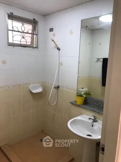Cozy bathroom with shower and modern sink in a stylish apartment