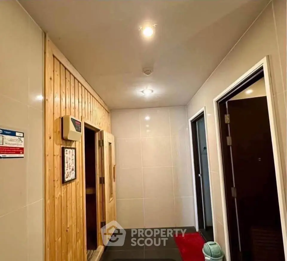 Modern sauna entrance in a residential building with sleek design and ambient lighting.