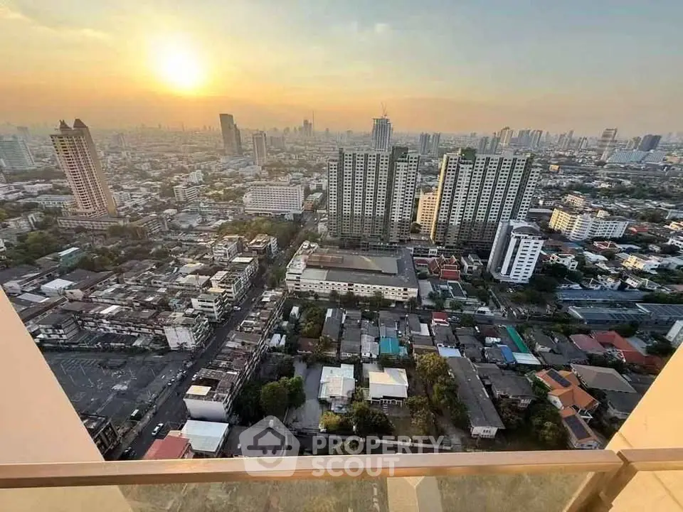 Stunning cityscape view from high-rise balcony at sunset, showcasing urban skyline and vibrant city life.