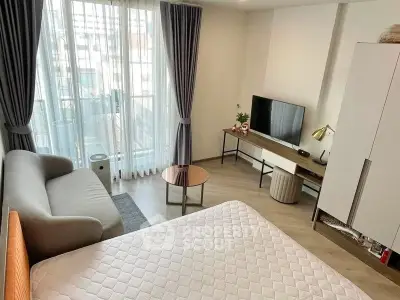 Modern studio apartment with cozy living area and natural light