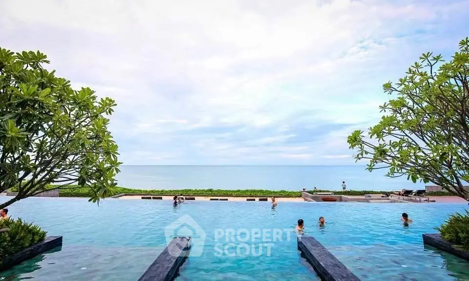Luxurious infinity pool with stunning ocean view and lush greenery, perfect for relaxation and leisure.