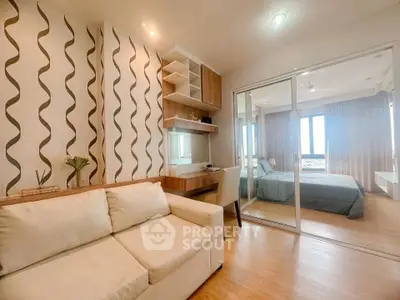 Modern living room with stylish decor and sliding glass doors to bedroom