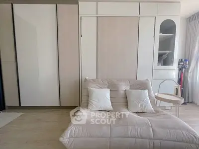 Modern bedroom with stylish furniture and built-in storage solutions