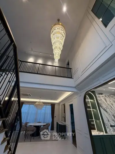 Luxurious modern interior with grand chandelier and elegant dining area