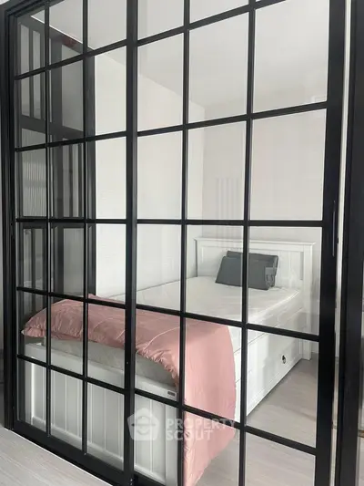 Modern bedroom with glass partition and stylish decor