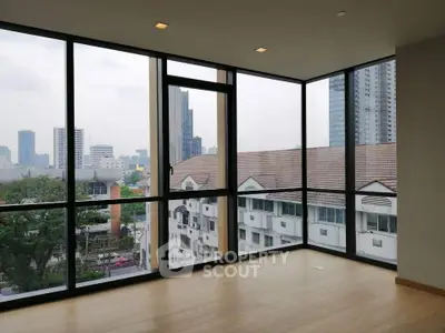 Spacious corner unit with floor-to-ceiling windows offering stunning city views.