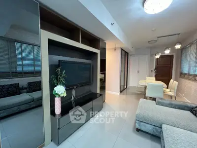 Modern living room with sleek furniture and open layout, featuring a cozy dining area and stylish decor.