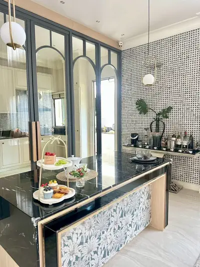 Luxurious kitchen with elegant black marble island and stylish decor