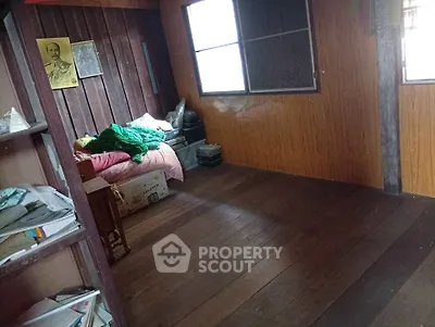 Rustic wooden bedroom with simple furnishings and natural light