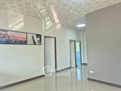 Spacious modern interior with elegant wall art and glossy flooring, perfect for stylish living.