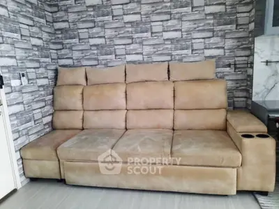 Luxurious beige sofa in modern living room with stylish stone accent wall