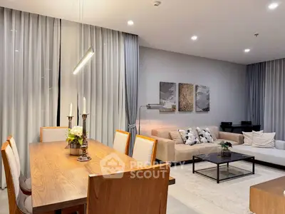 Elegant living room with modern decor, cozy seating, and stylish dining area, perfect for entertaining.