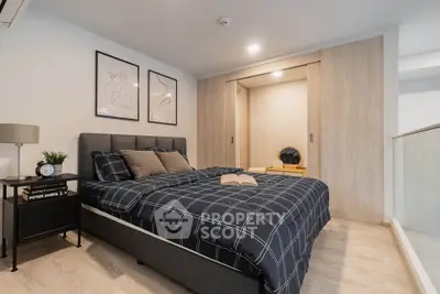Modern bedroom with stylish decor and cozy ambiance, featuring a comfortable bed and elegant furnishings.