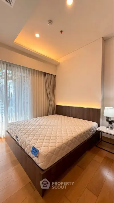 Spacious bedroom with modern design and large window for natural light