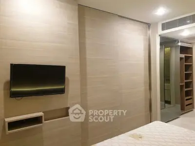 Modern bedroom with built-in TV and stylish wooden paneling