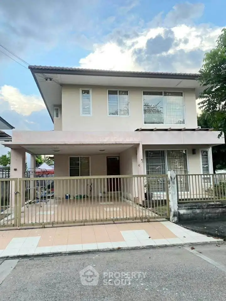 Charming two-story house with spacious driveway and modern exterior design.