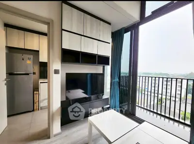 Modern living room with balcony view and sleek kitchen design