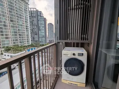 Modern high-rise balcony with washing machine and city view