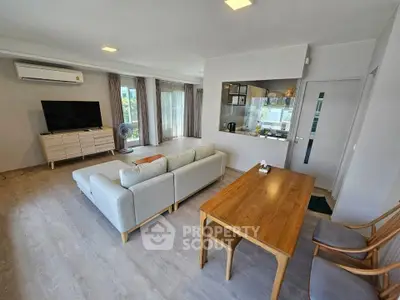 Spacious living room with modern decor and large windows for natural light.