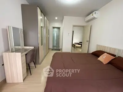 Spacious modern bedroom with stylish decor and ample storage space.