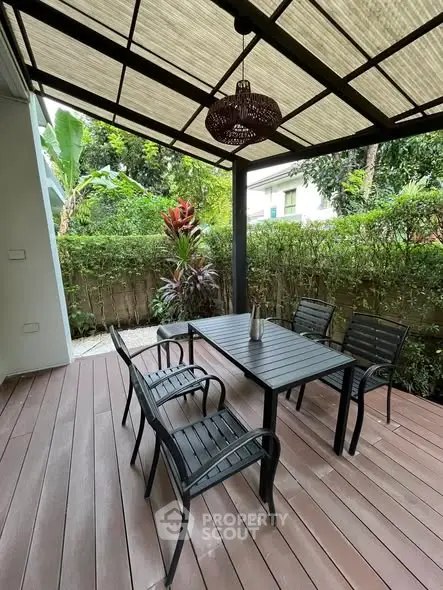 Charming outdoor patio with elegant dining set and lush garden view