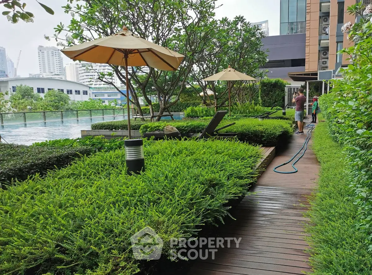 Luxurious garden area with poolside view in modern residential complex