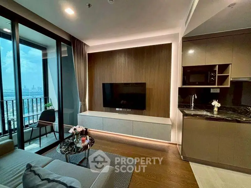 Modern living room with sleek design and city view balcony, featuring a wall-mounted TV and stylish furniture.