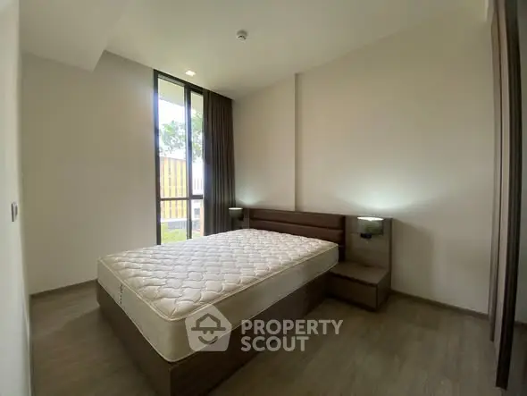 Modern bedroom with large window and minimalist design