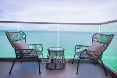 Stunning ocean view from a modern balcony with stylish seating.