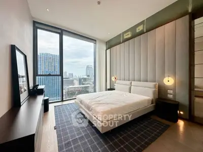 Modern bedroom with large window offering city view and stylish decor