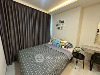 Cozy bedroom with modern decor and stylish bedding in a well-lit apartment.