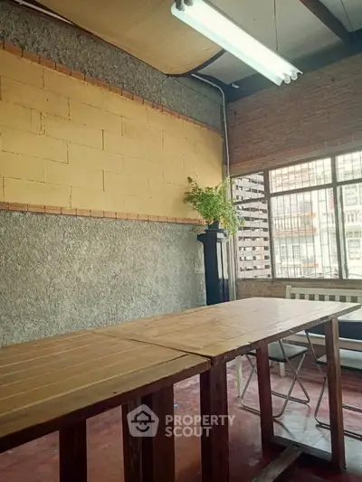 Spacious study room with wooden table and natural light