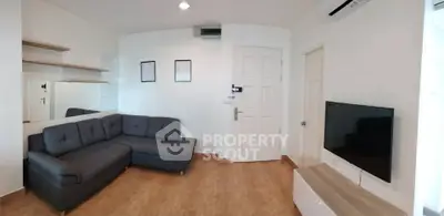 Modern living room with sleek furniture and wall-mounted TV