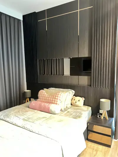 Modern bedroom with stylish dark wood paneling and cozy decor