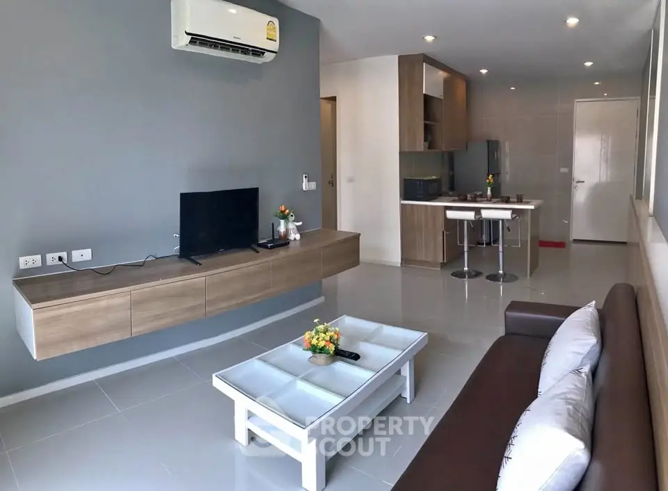 Modern living room with sleek furniture and open kitchen layout