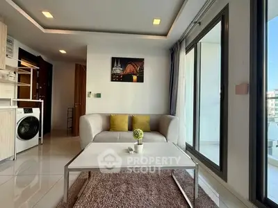 Modern living room with sleek design and balcony access in a stylish apartment.