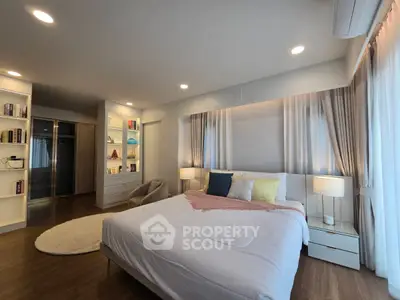 Spacious modern bedroom with elegant decor and ample natural light
