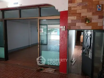 Spacious interior with sliding glass doors and tiled flooring, ideal for versatile real estate opportunities.