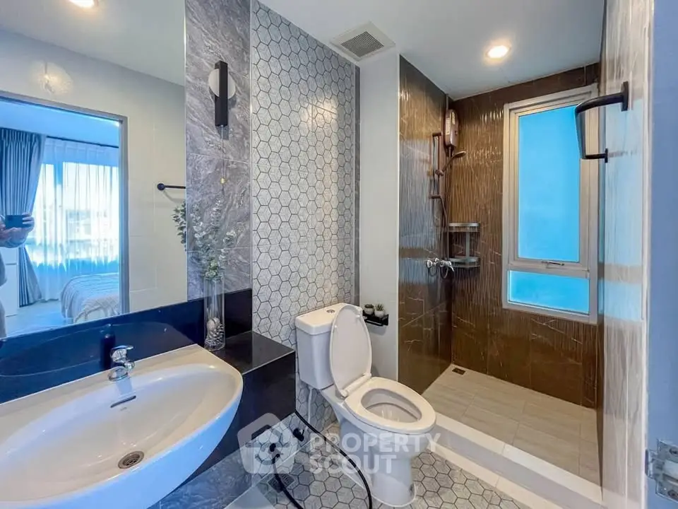 Modern bathroom with stylish tiles and glass shower enclosure